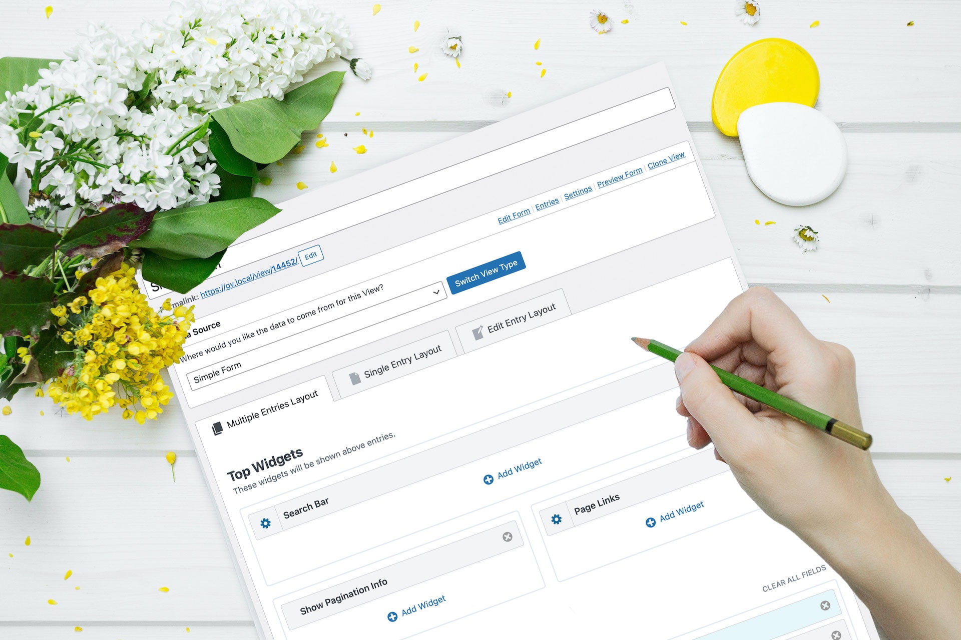 Spring flowers and a hand drawing on a screenshot of the new GravityView UI